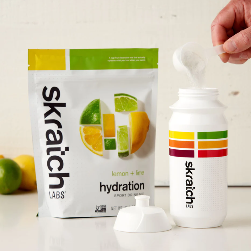 Hydration Sport Drink Mix (20 Servings), Skratch Labs Hydration Sport Drink Mix being scooped into water bottle