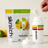 Skratch Labs Hydration Sport Drink Mix being scooped into water bottle