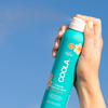 COOLA Classic Body Organic Sunscreen Spray SPF 70 spraying