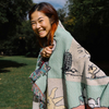 Parks Project Peanuts x Parks Project Woven Blanket over shoulders
