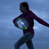 HQ Kites & Designs Skylighter Frisbee lit up at night