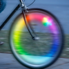 Nite Ize SpokeLit Rechargeable Disco-Select Wheel Light on bike wheel